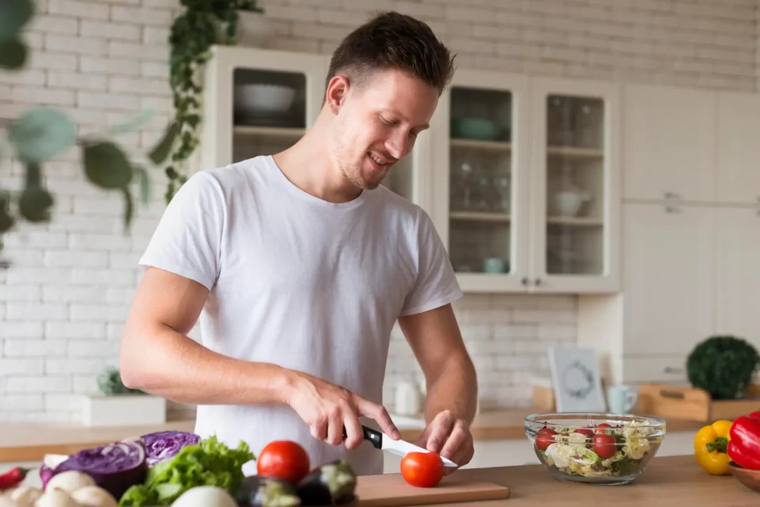 Homem preparando alimentos saudáveis. A alimentação balanceada é um dos pilares de um estilo de vida saudável.