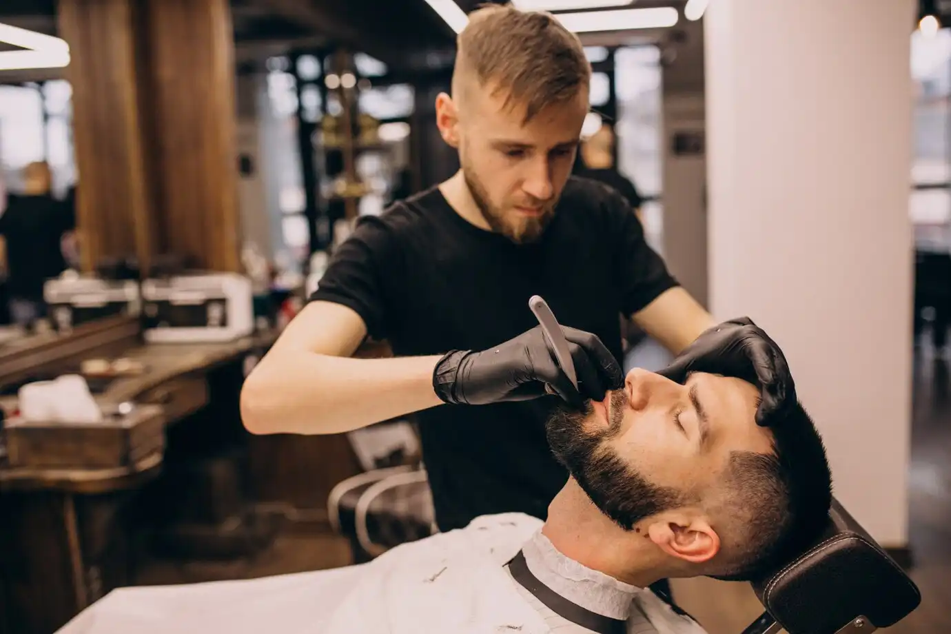 Homem fazendo a barba numa barbearia.
