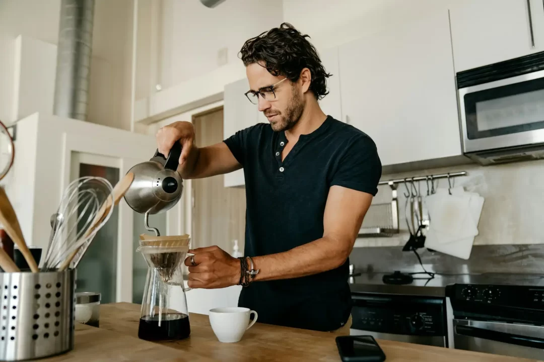Homem preparando café em sua rotina matinal.